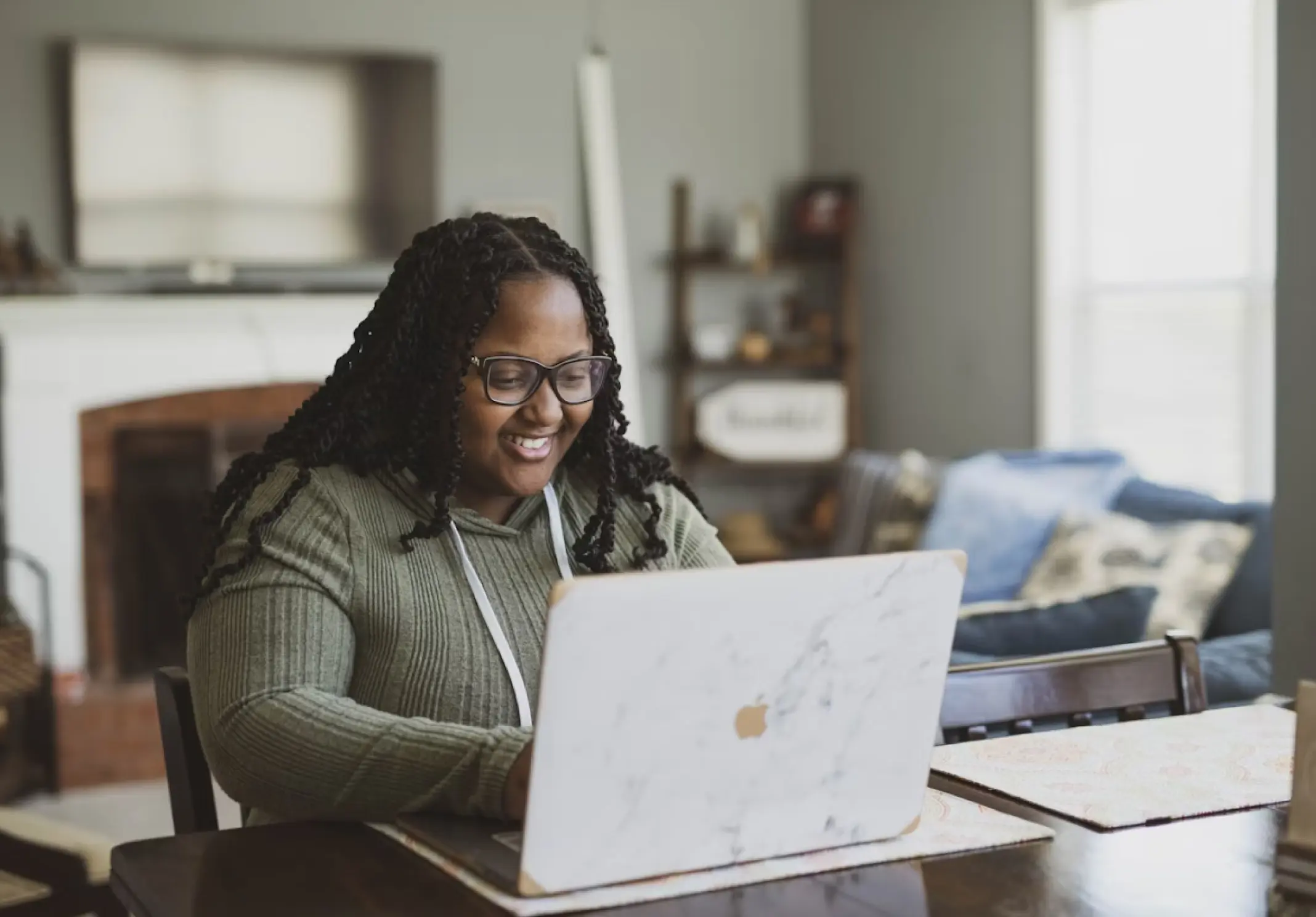 A woman enjoying work on her laptop